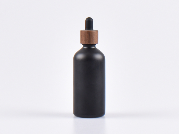 glasflasche-schwarz-pipette-holz-montur